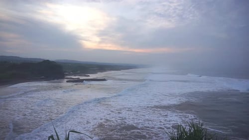 big waves of sea water during low tide in the morning at sunrise