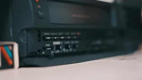 Hand Taking a VCR Tape Out of Player