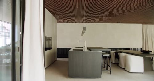 Kitchen island, bar stools, sink with faucet and dining table at cottage house