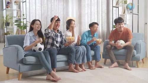 Teenagers Cheering And Watching Football Game On Tv. Team Celebrating Victory And Team Disappointed