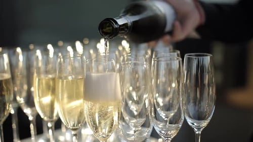Pouring Champagne into Flutes for Celebration
