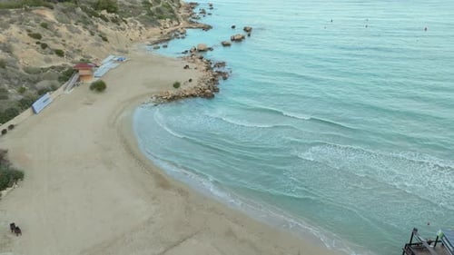 Peaceful Cyprus White Sand Beach at Sunset Time, Small Mediterranean Sea Waves Rolling Towards Islan