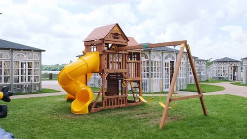Children's playground made of wood in the courtyard. Close-up, swing and slides in the fresh air