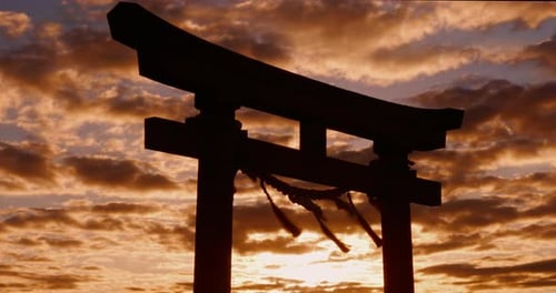 Sunset, torii gate and skies in shrine, holy place and spiritual for worship, gods and religion