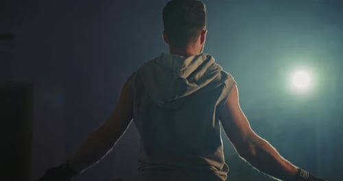 Active Man Jumping Skipping Rope in Sport Club