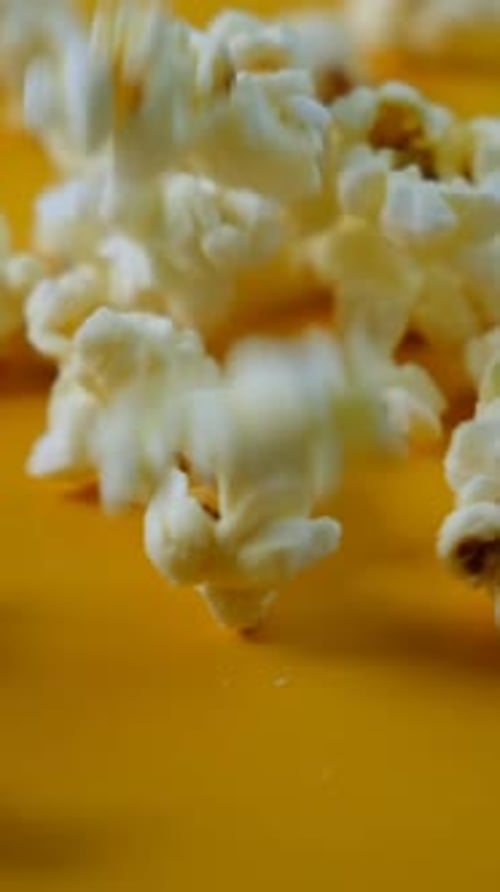 Popcorn Falling in Slow Motion on Yellow Background