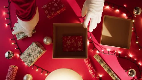Santa Placing Presents in Box for Christmas