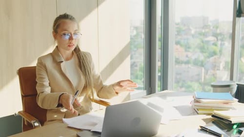 A Focused Businesswoman is Working at a Modern Office with a Scenic City View She is Busy with