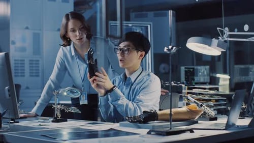 Technological Prosthetic Robot Arm is Tested by Two Professional Development Engineers in a High Te