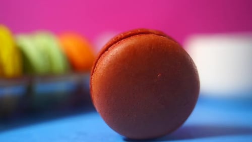 Close Up of a Chocolate Macaron on Blue Surface