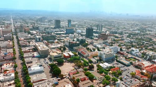 Urban landscape of modern Los Angeles, California, USA. City at backdrop is covered with thick fog.