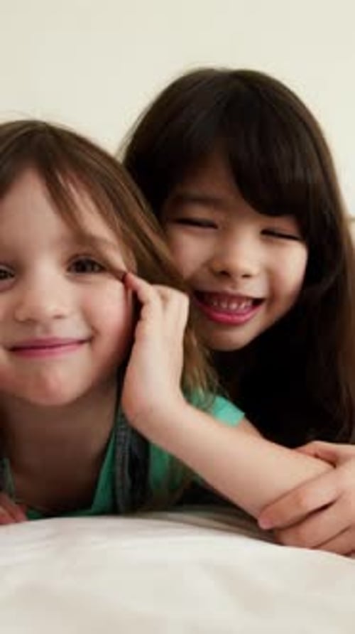 Two Cheerful Girls Smiling at the Camera