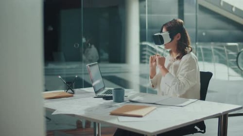 Woman Wearing VR Glasses Sits in a Bright Office Innovative Technologies