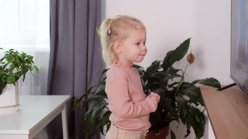 A Girl with a Cochlear Implant Watches TV and Hears Sounds