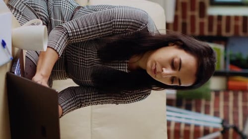 Young Adult Working on Laptop at Home