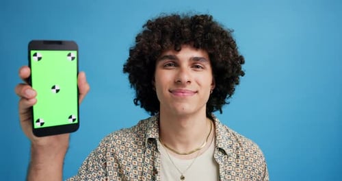 Phone, green screen and man in studio with technology, ux design or tracking marker on website