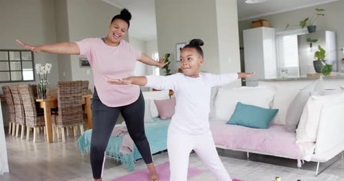 Woman and Child Practicing Yoga at Home