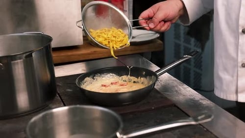 Chef Preparing Pasta in Restaurant Kitchen