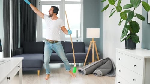 Man Dancing with Broom in Living Room