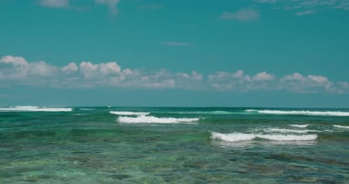 Endless Ocean Horizon with Wide Turquoise Waves and Blue Cloudy Sky at Sunny Summer Day