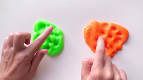 Playing with Textured Slime with Bubbles Stretching the Gooey Substance