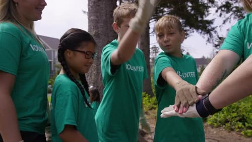 Group Of Volunteers Cleaning Up Park