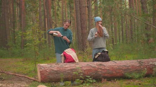 Hikers Refresh with Water and Haircare in Peaceful Forest