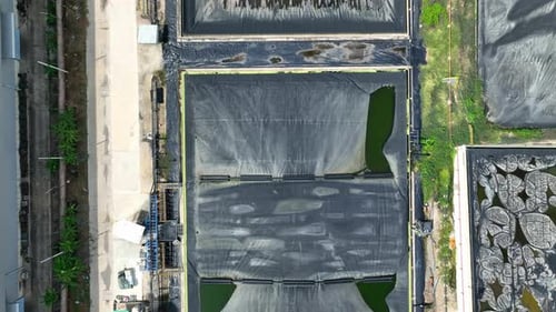 Drone view shows multiple lined waste containment ponds.