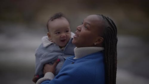Mother Holding Young Baby Child Boy Outside Enjoying Family Life