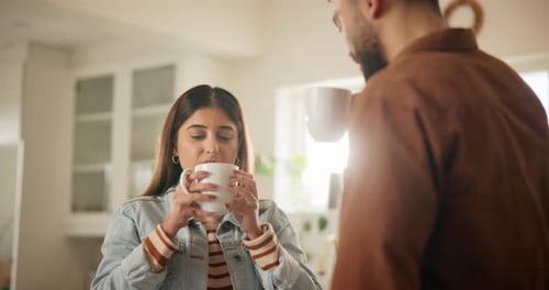 Young Couple Drinking Coffee Together in Bright Kitchen