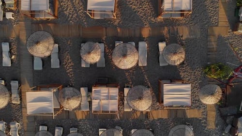 The Camera Flies Vertically Up Over the Sun Loungers on the Beach
