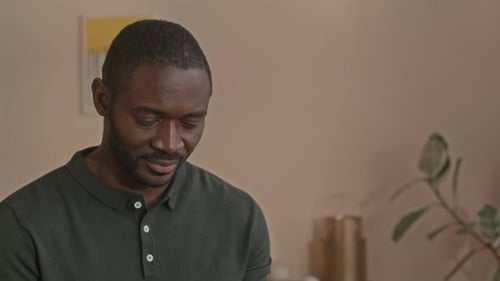 Black Man Using Digital Tablet at Home Office