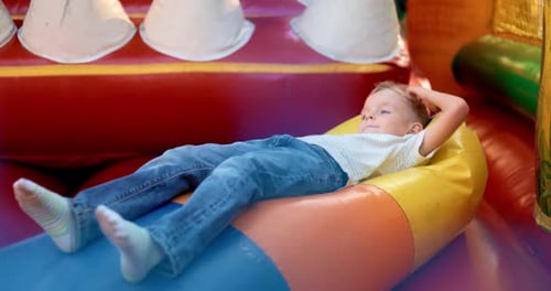 Child Playing in Colorful Inflatable Bounce House