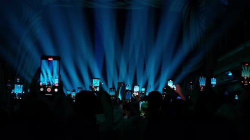 Crowd Captures Concert with Phones in Blue Light