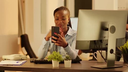 Young Woman Video Chats on Phone in Office