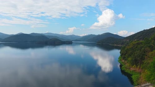 Mountain Range Reflected in the Water's Surface with Clouds Reflecting in the Lake