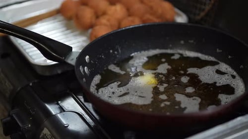 Woman making sata andagi