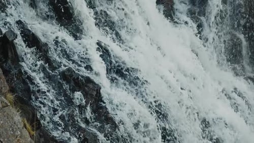 Slow Motion Footage of Foaming Waters While Falling Inside a Waterfall
