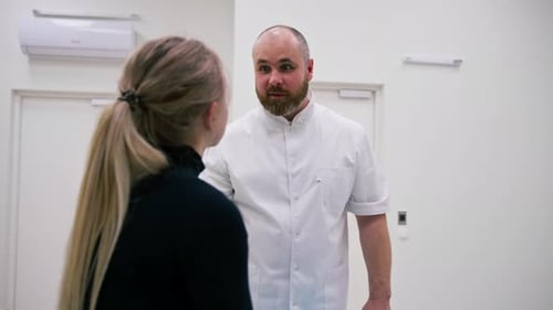 A doctor consults a patient in a medical clinic before an X-ray computed tomography procedure