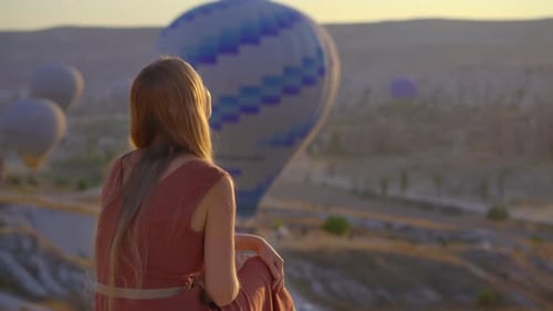 Tourist Woman Looking at Hot Air Balloons in Cappadocia Turkey Happy Travel in Turkey Concept Woman