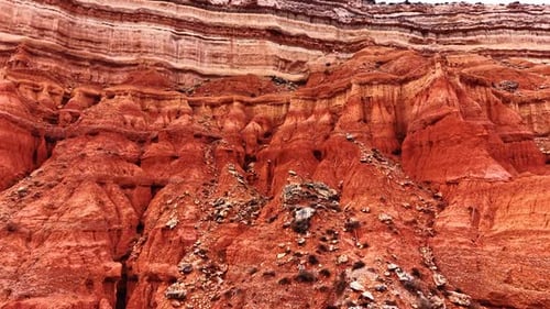 Jagged red rock formations and eroded earth textures.