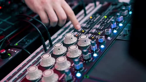 Close Up in Dark Recording Studio the Sound Engineer Works with the Remote Control and Connects the