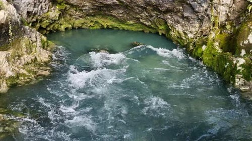 Clear Aqua Water Flowing Through Rocks to the Creek