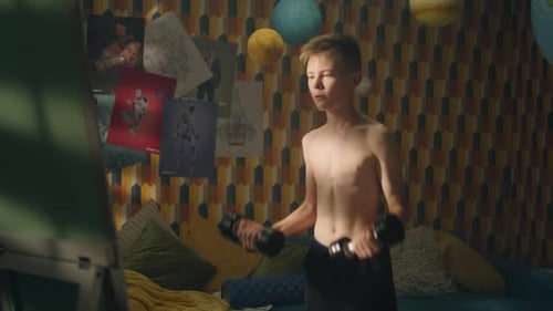 Boy Doing Arm Exercises with Dumbbells in Room