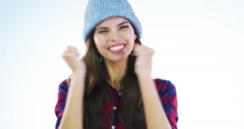 4k video footage of an attractive young woman looking excited against a grey background