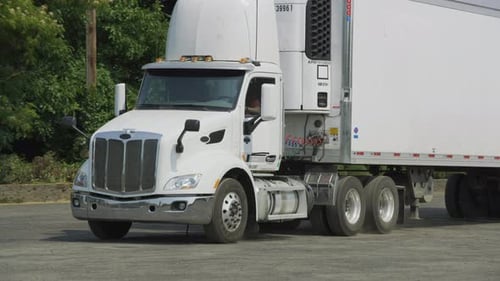 Semi truck delivers freight to warehouse in rural america