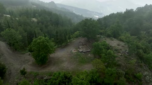 Clouded Enchantment Aerial Perspective of the Serpentine Road and the Mystical Forest in Dramatic
