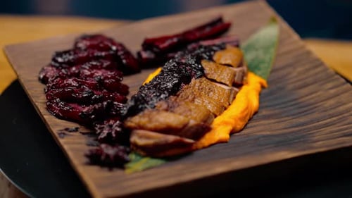 close-up of a dish pieces of juicy roasted duck with puree on a plate Asian cuisine restaurant
