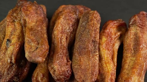 Golden Candied Bananas on a Black Surface