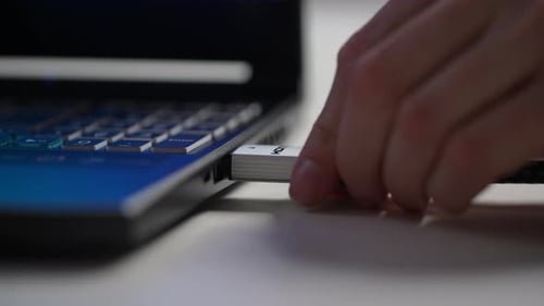 Extreme Closeup of Unrecognizable Man Removing HDMI Cable From Side Port of Laptop Computer